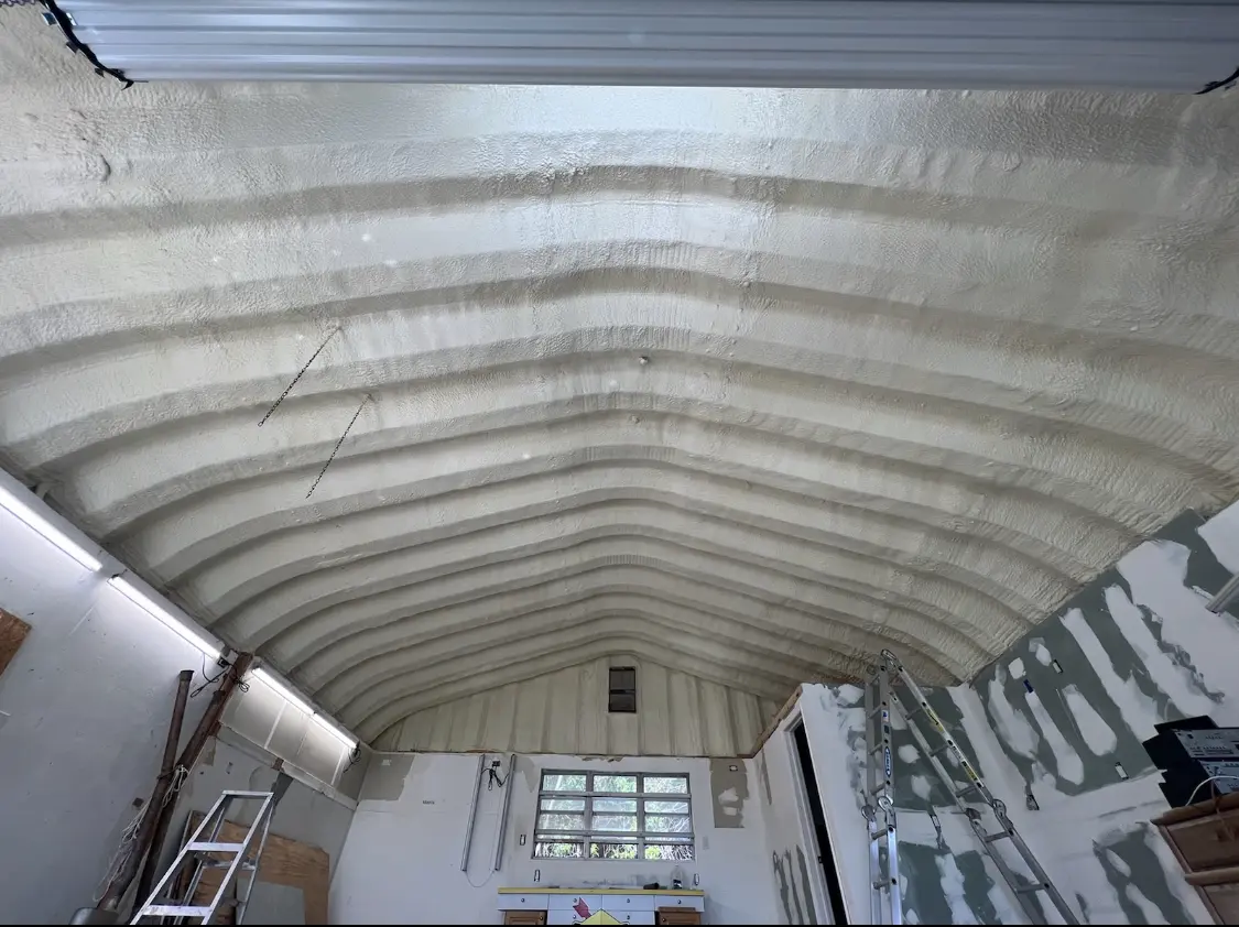 Spray polyurethane foam applied to the underside of a metal roof deck in San Marcos